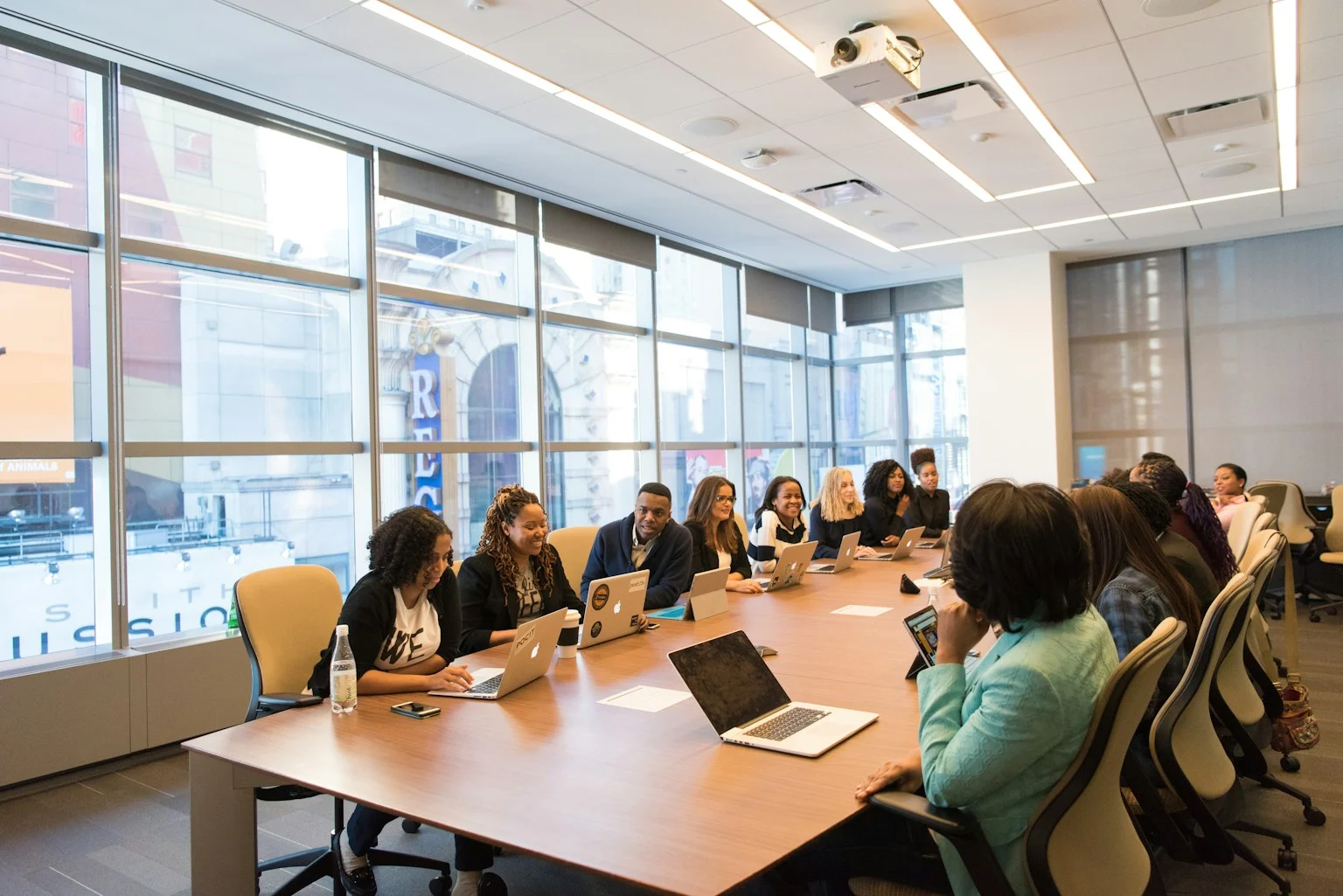 Colleagues in conversation around a meeting table.